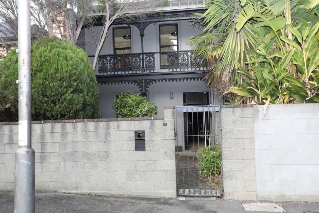View of the fronet of 126 Gatehouse St showing fence, facade and lighis inside front room